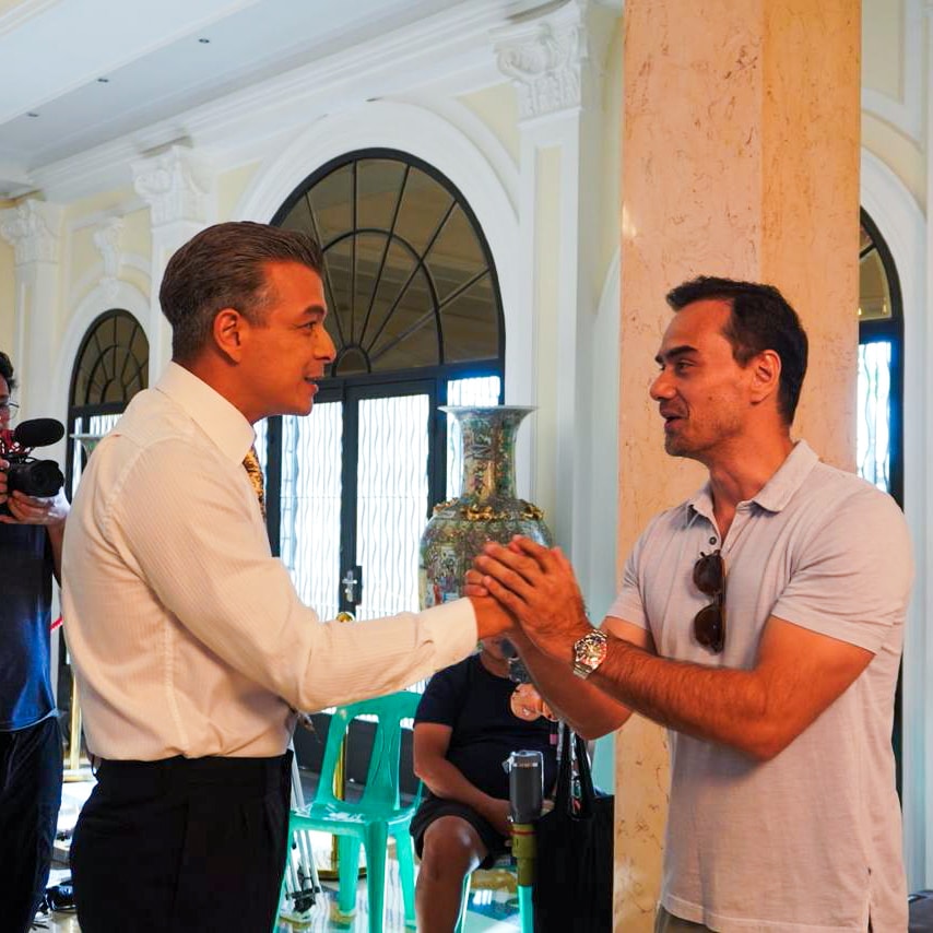 Jericho Rosales and TJ Trinidad exchange handshakes at the set of "Quezon." Image: Courtesy of TBA Studios